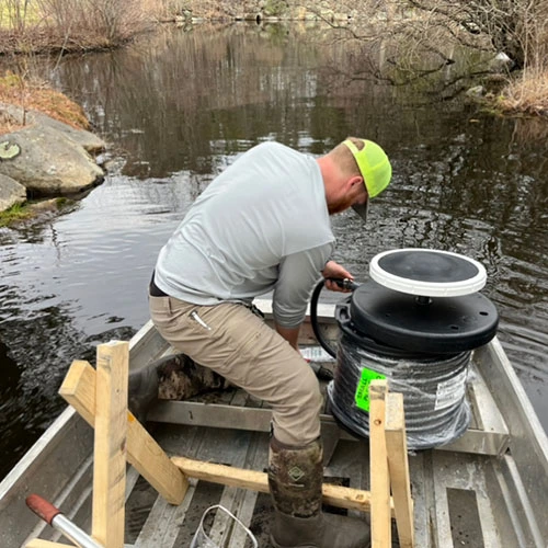 man on a boat installing an aeration system